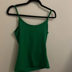 Grön linnetopp från Zara - Snygg grön linnetopp från Zara i storlek M. Perfekt för sommardagar eller som ett lager under en jacka. Toppen har smala axelband och är i ett mjukt och bekvämt material. Ett måste i garderoben för en stilren look! 💚