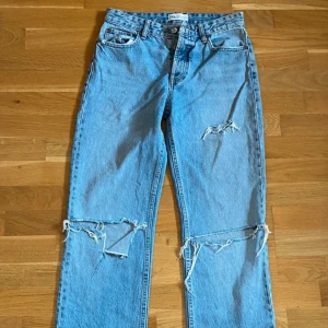 Jeans från Zara!  - Säljer ett par ljusa jeans med coola slitningar på knäna och låren. De har en klassisk femficksdesign och är perfekta för en avslappnad stil. Jeansen har en rak passform och är i mycket bra skick! Perfekta för både vardag och fest! Intresserad och vill ha flera bilder, hör av dig! 