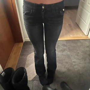 Svarta och blå jeans fråga gintricot - Två par jeans, ett par i svart och ett i blått. De svarta jeansen har en tight passform och låg midja men också mot bootcut hållet, medan de blå jeansen har en bootcut-stil. Perfekta för en avslappnad look. Dem svart har där bak fickor med knappar, medans dem blåa där back har fickor med mönster på💓man kan välja att köpa båda för 200kr om man bara vill köpa en av dem så kan man få ett par för 100krst