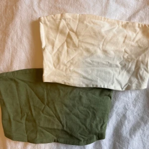 Två tubtoppar från H&M Divided - Säljer två tubtoppar från H&M Divided i storlek XS. En i beige och en i olivgrön färg. Perfekta för sommaren och kan enkelt matchas med olika outfits. 😍💚
