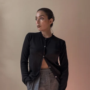 Vintage Marni Black Wool Cardigan - Vintage Marni Cardi Sweater in Wool Blend. Black Crewneck with tonal buttons.  Cutout Detail in the Back Neckline  Some signs of wear with pinholes that have been sewn up, reflected in price. Overall Good Condition  Made in Italy  Wool/Silk Composition