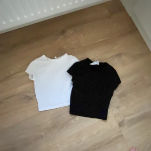 Svart och vit t-shirt från Weekday - Två stilrena t-shirts från Weekday i svart och vitt. Perfekta basplagg för garderoben. Båda är kortärmade och gjorda i mjukt material för en bekväm passform.