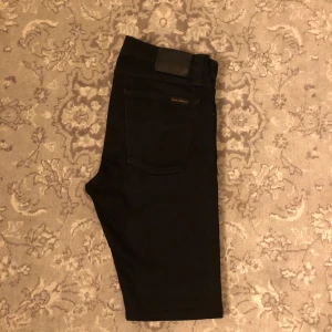 Svarta Nudie jeans - Säljer nu dessa fräscha svarta Nudie jeans med en snygg tvätt| finns inga defekter på jeansen och är knappt använda| De är i storlek W29 L32 och har bra passform| vid några frågor eller funderingar är det bara att höra av sig!