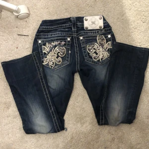 Mörkblå jeans med paljettdetaljer - Snygga Miss me jeans med paljetter på fickorna! Uppsydda 8cm på längden. Har lite hål längst ner!