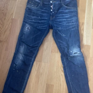 Blå jeans från Dsquared2 - Säljer ett par snygga blå jeans från Dsquared2 i bra skick. Dem är knappt använda kvitto följer såklart med,storlek är 50 på dem men dem passar mig som är 180 cm och väger 71 kg, priset kan diskuteras men bara med seriösa köpare. 