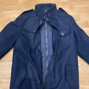 Stilig jacka från INDIGO - Hej! Säljer nu denna sjukt snygga och stiliga jacka från märket INDIGO. Den är helt oanvänd. Jackan är marinblå och är i storlek Medium🤗 Den är varm för vintern, hör av er om det är något😄Köpt ca 2 veckor sedan för 1800kr.