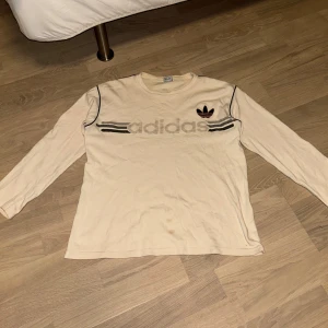 Långärmad adidaströja - supersnygg beige adidaströja med coolt tryck🎀 storlek L men passar mindre storlekar (jag är S). tröjan har en fläck på armen som antagligen går bort i tvätten! hör av dig vid frågor/prisförslag❤️