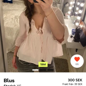 Ljusrosa blus med spetsdetaljer - Säljer en söt ljusrosa blus med spetsdetaljer och knytning framtill. Blusen har trekvartsärmar och en luftig passform. Säljer för att den inte kommer till användning, köpt här på plick.