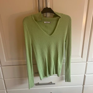 Grön ribbad tröja från NA-KD - Snygg ljusgrön ribbad tröja från NA-KD med v-ringning. Väldigt stor i storleken