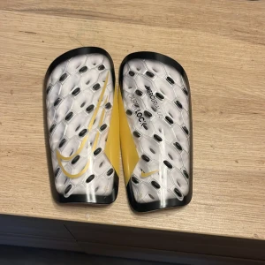 Nike benskydd - Säljer ett par Nike Mercurial Lite Superlock benskydd. De är väldigt bra för en fotbollsspelare, har aldrig använt dem. 