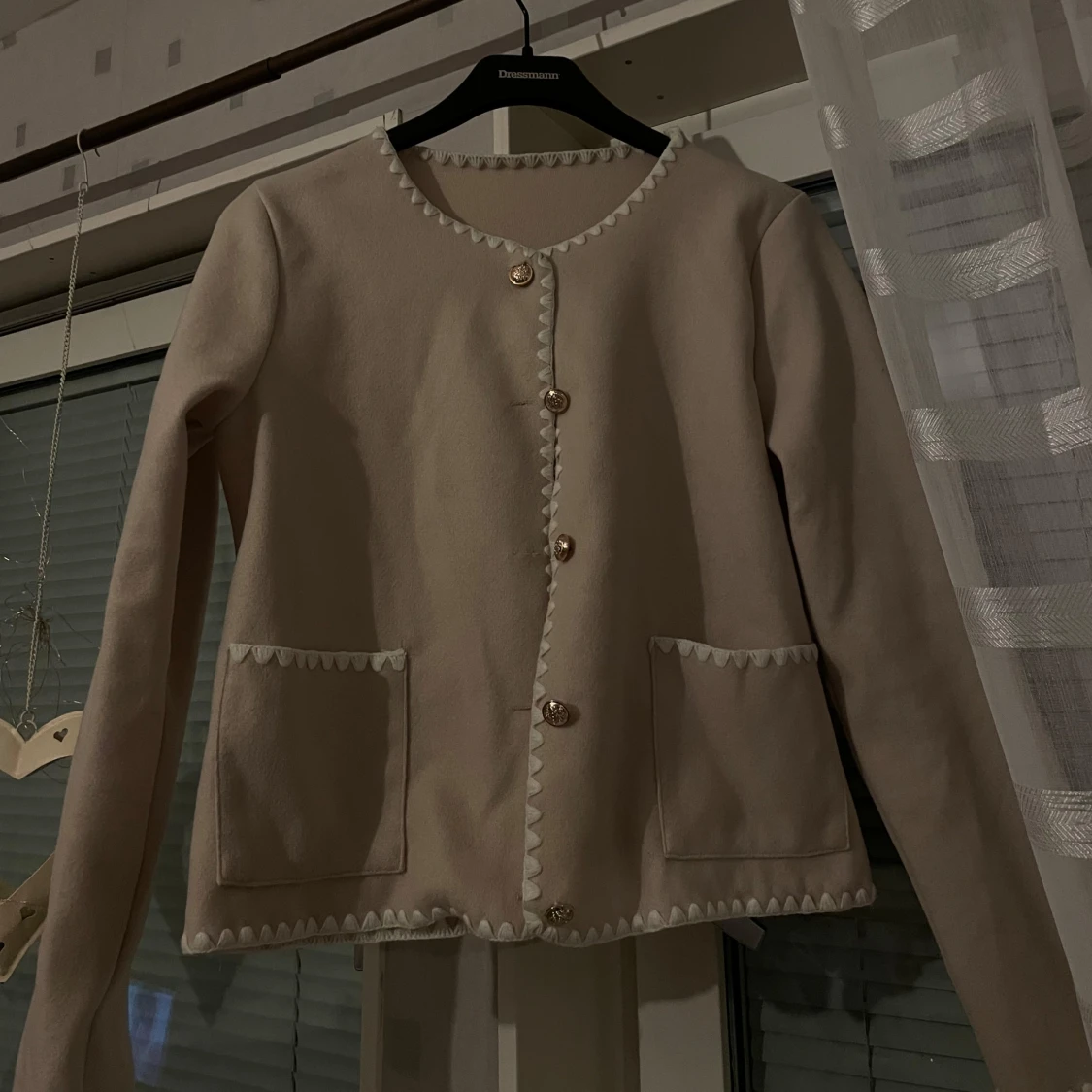 Beige kavaj med dekorativa knappar