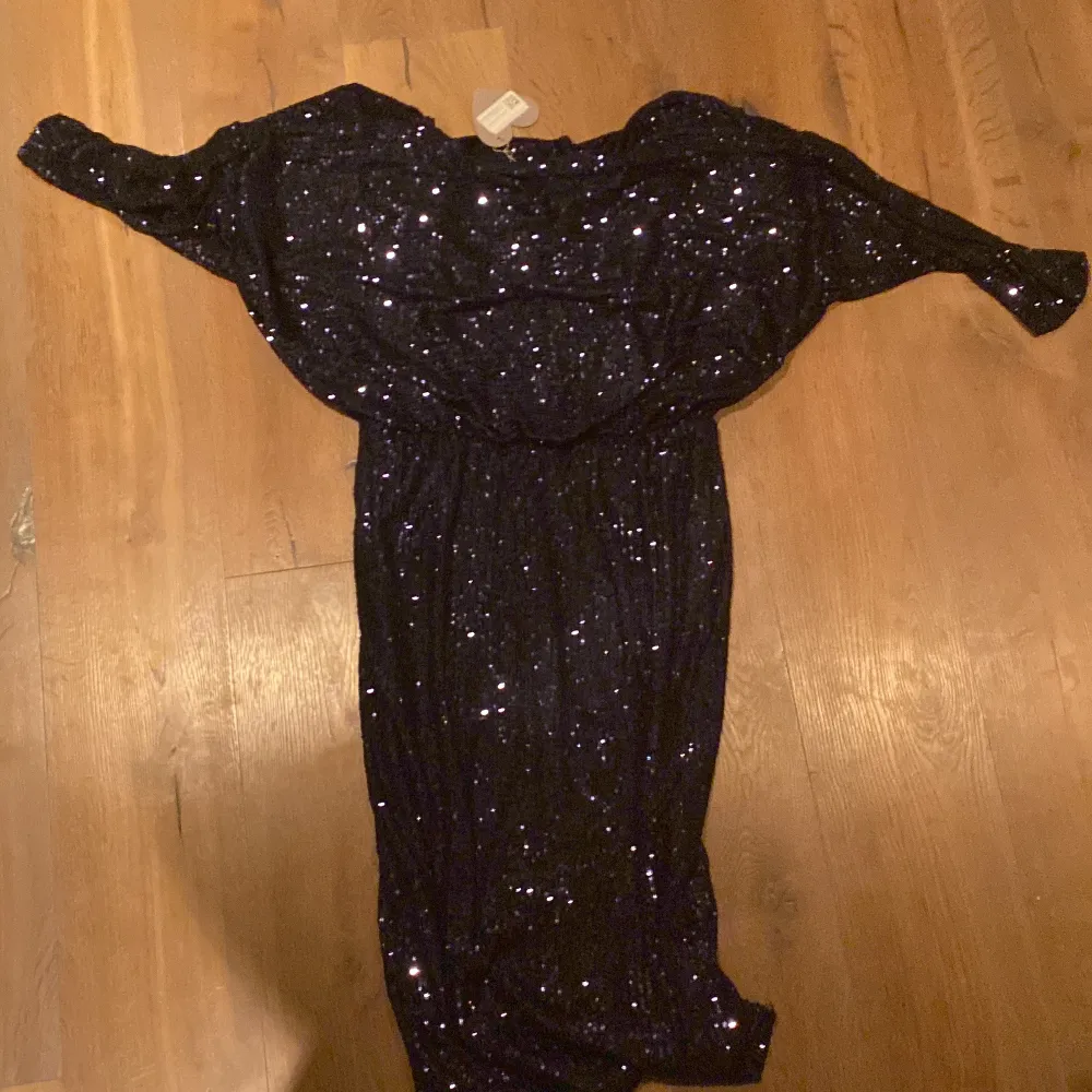 Säljer en elegant mörkblå klänning från Goddiva med glittriga paljetter. Klänningen har en cowl neck och är långärmad, perfekt för en festlig kväll. Den är i en smickrande passform som framhäver figuren. Perfekt för att glänsa på nästa event! ✨ord pris 715kr. Mekot.