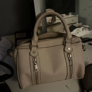 Beige handväska - Snygg beige handväska använd några gånger men inte mycket som märks. 
