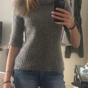 Grå stickad polotröja - Mysig grå stickad polotröja med trekvartsärmar. 