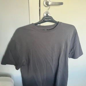 Mörkgrå t-shirt - Säljer en mörkgrå t-shirt som knappt är använd. Storlek S men sitter som M.