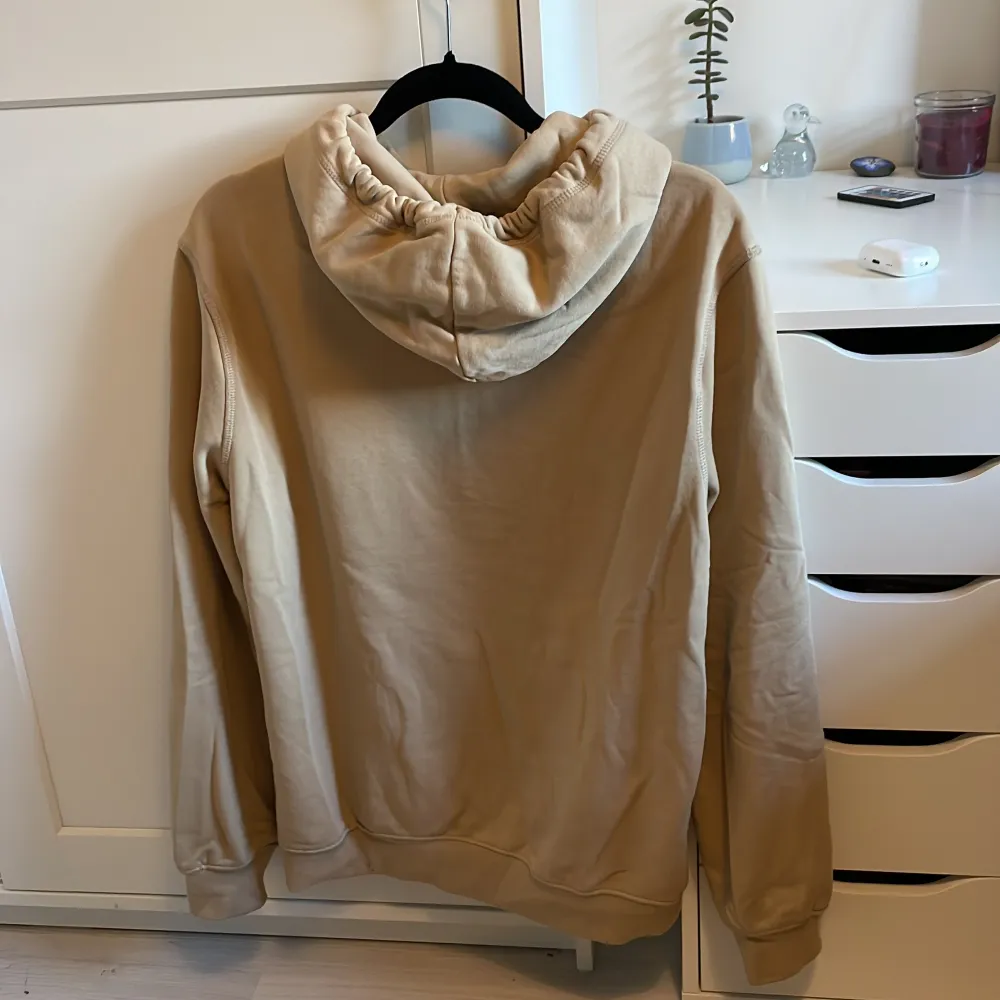 Säljer en supermysig beige hoodie från H&M. Den har en klassisk känguruficka och en justerbar huva med dragsko. Perfekt för chilliga dagar eller när du bara vill ha något bekvämt på dig. Den är i bra skick! . Hoodies.