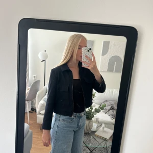 Höstjacka - Höstjacka i denim, i färgen blå/svart och croppad modell. I mycket fint skick, knappt använd. Dragkedjorna i ryggen kan öppnas för en att göra jacka bredare. 