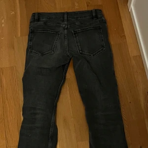 Svarta jeansbyxor - Snygga svarta jeansbyxor med klassisk femficksdesign och knappgylf. Perfekta för en stilren look. Passar till många olika outfits.