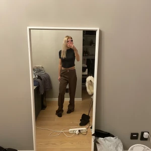 Bruna kostymbyxor  - Bruna kostymbyxorn med snörning från nakd! Säljer då de var för stora och för långa för mig!  Nya med prislapp