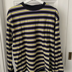 Cool randig långärmad tröja! - Jättesnygg randing långärmad tröja från Junkyard i retrostil! Trycket är lite ”sprucket” på vissa ställen men i övrigt är tröjan i bra skick 💜  Frakt är inte inkluderat i priset! 🩷