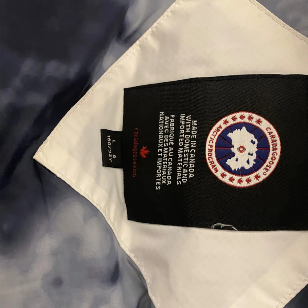 Säljer en snygg vit dunväst från Canada Goose i mycket bra skick. Västen har en dragkedja framtill och två praktiska fickor. Perfekt för kyliga dagar när du vill hålla dig varm och stilren. Passar till både vardag och fest!. Jackor.