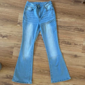 Ljusblå bootcut jeans - Säljer ett par ljusblå bootcut/flared jeans i bra skick. De är perfekta för både vardag och fest. Jeansen har en snygg utsvängd stil. De har blivit använda max två gånger!