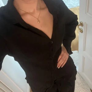 Svart skjorta - Fin svart skjorta i ett krinklat material. Använd ett fåtal gånger endast🩷