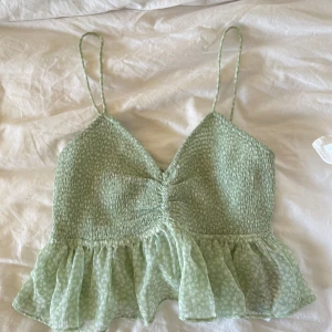 Grön topp - Jättefin grön sommartopp! Använd fåtal gånger. Snörning i ryggen så man kan justera storlek och bandens längd. Pris kan diskuteras!🥰