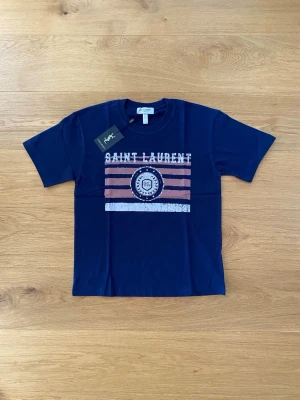 Saint Laurent t-shirt M - Marinblå saint Laurent t-shirt. Sjukt snygga. Storlek M. Ordinarie pris runt 5000. Köpt från leverantör, därav pris! Bara att skriva vid funderingar.