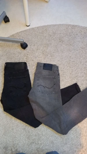 Jack and jones jeans i svart och grått - Två par snygga jeans från Jackandjones, ett par i mörk svart och ett par i grått. Klassisk femficksmodell med raka ben. Perfekt passform och stilren look, tillverkade i mjukt jeanstyg. Säljer båda för 400 eller enskilda för 250 var🤝