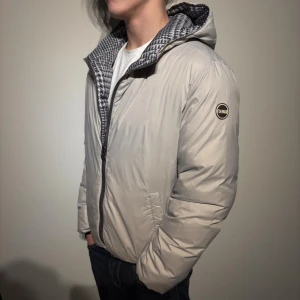 Colmar Dunjacka - En colmar dunjacka som är vändbar.  Fint skick förutom ett litet hål på luvan som är på den beige sidan. Passar S. Hör av er vid frågor!