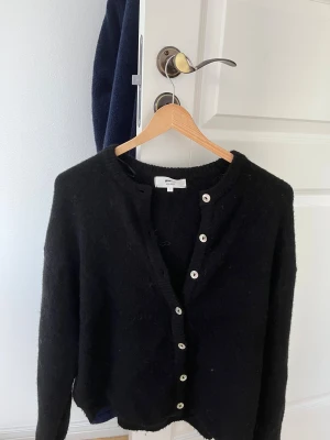 Svart kofta från Ganni i ull - Svart kofta från Gina. Super fin bra skick inte använt mycket alls. 