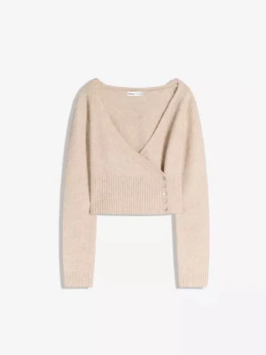 Beige omlott kofta med knappar - Säljer en beige omlott kofta från Monki med croppad passform. Tröjan har ribbade muddar, v-ringning och dekorativa knappar på sidan. Perfekt för lager på lager och en mysig höstlook.