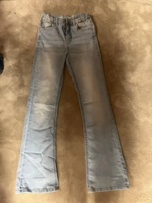 Ljusblå wide jeans från LAB Industries - Ljusblå jeans från LAB Industries i storlek 158. Jeansen har en rak och wide passform med klassisk femficksdesign och normal midja. Tillverkade i hållbar denim och perfekta för en avslappnad look.