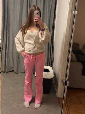 Rosa jeans från fornarnia - Rosa lågmidjade jeans från fornarnia. Storlek 27. Innerbenslängden är ca 86cm. Tunnare än vanligt jeanstyg 