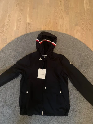 Moncler Vindjacka Svart - Svart Moncler Windbreaker. Storlek 1 (Motsvarar S). NFC scan fungerar. Tar ej emot byten och priset går tyvärr ej att diskuteras. Fråga gärna för fler bilder eller funderingar.