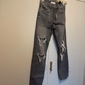 Grå ripped jeans från Zara - Säljer ett par grå jeans från Zara i storlek 36.