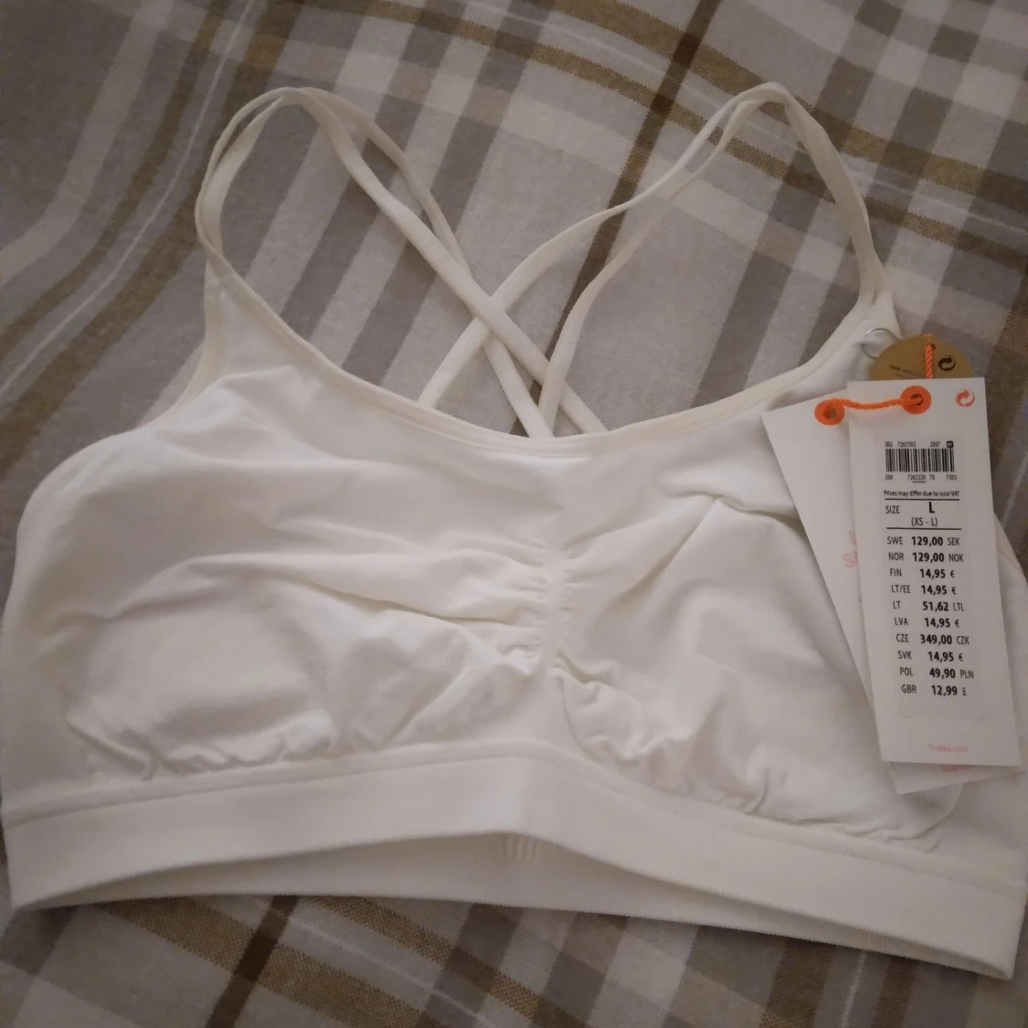 HELT NY OANVÄND vit sporttopp med korsade axelband Lindex, Strlk ca 34-36.