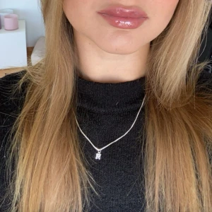 Halsbandsberlock i silver med bokstaven M - Snyggt halsbandshänge i form av bokstaven M, tillverkat i silver. Perfekt att sätta på din favoritkedja för en personlig touch. Hängsmycket är litet och stilrent, passar dig som vill ha något enkelt men ändå unikt. 