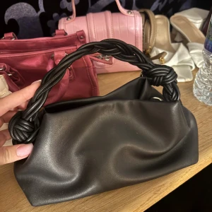 Svart handväska med flätat handtag - Svart väska använt mycket men inte mycket tecken på använd!