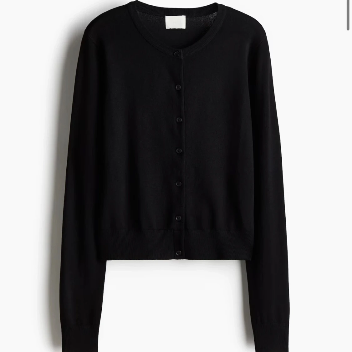 Svart kofta från H&M med knappar