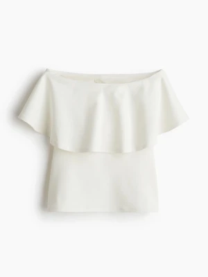 Topp H&M - En superfin bandeautopp med volang framtill från H&M. Den är helt slutsåld och finns inte kvar att köpa, är aldrig använd och har prislappen kvar! Hör av dig för fler bilder eller vid frågor💕