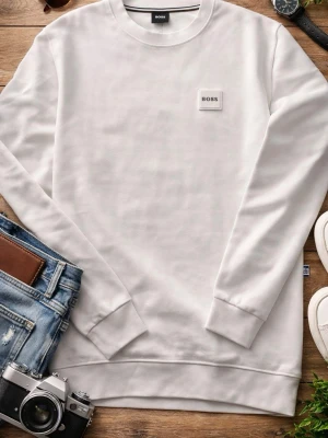 Vit sweatshirt från BOSS - Snygg vit sweatshirt från BOSS med rund halsringning och diskret logotyp-patch på bröstet. Tröjan har en klassisk passform, ribbade muddar vid ärmslut och nederkant. Perfekt för en clean och stilren look.