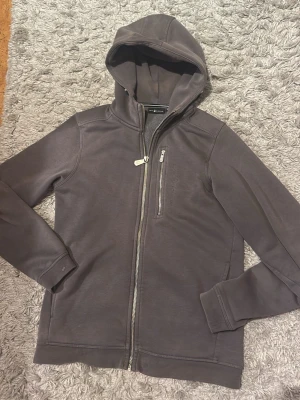 Sail Racing Zip Up  - Sail racing zip up som är mörk grå. Mycket fin, dock sliten och väl använd. Har vissa blekta partier och armbågarna på jackan är slitna vilket gör att priset sänkts enormt. 
