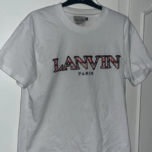 Vit Lanvin x Gallery Dept t-shirt - Vit t-shirt från Gallery Dept. med Lanvin Paris-tryck framtill. Väldigt bra skick, 8/10. Storlek M, passar M-L.