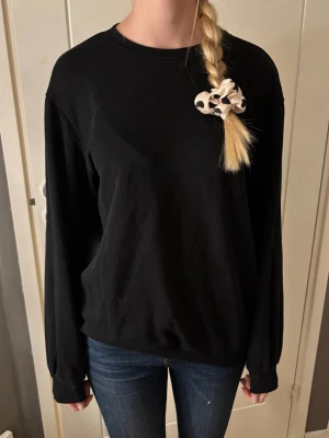 Svart långärmad sweatshirt - En enkel svart långärmad sweatshirt med rund hals och loose passform. 