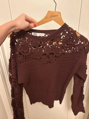 Vinröd stickad tröja med spets från Zara - Säljer en brun stickad tröja från Zara med snygga virkade spetsdetaljer 