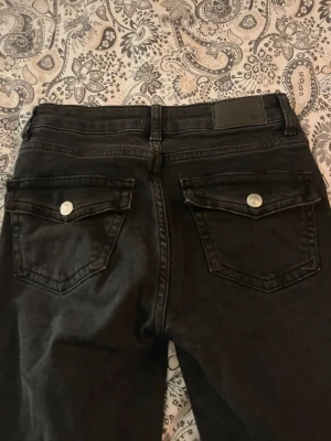 Svarta jeans – XS – 90s boot – Full length - Snygga svarta jeans i storlek XS med 90s boot-modell. Full length med lätt utsvängda ben som ger en klassisk 90-talslook. Sitter fint över höfter och lår. Använda men i fint skick. Passar perfekt både till vardag och mer uppklädda outfits.