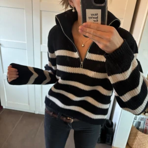 Svartvit randig stickad tröja med half zip - Säljer en svart och vit randig stickad tröja med ribbad struktur och halv dragkedja i halsen.  Den är as snugg och super skön, silvrig dragkedja och perfekt längd 💕 köptes på Lindex för något år sedan men har inte blivit så använd 