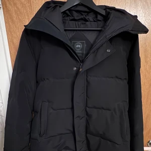 Canada Goose black label - Säljer en äkta Canada Goose Black Label-jacka i utmärkt skick. Haft den i nästan ett år men har använt den endast i två månader, nästan som ny. Varm, stilren och exklusiv modell. Perfekt för dig som vill ha både kvalitet och tidlös design. 